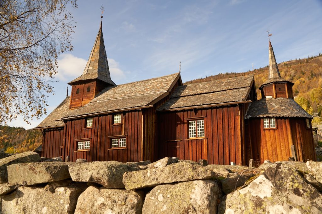 a-wooden-church-with-two-steeples-on-top-of-it-9r7aoawut-m Hol Old Church by Holsfjord, 15 mins from Geilo. Originally a 13th-century stave church expanded over time, it stands as a testament to Norways architectural heritage.
